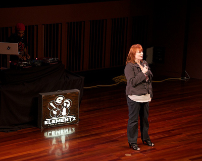 Elle Morris on stage Stop pay attention and listen
